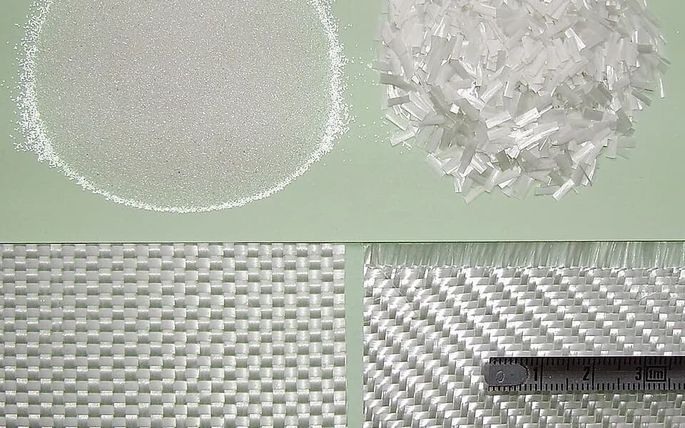 Glass fiber reinforcements including chopped strand and woven fabrics